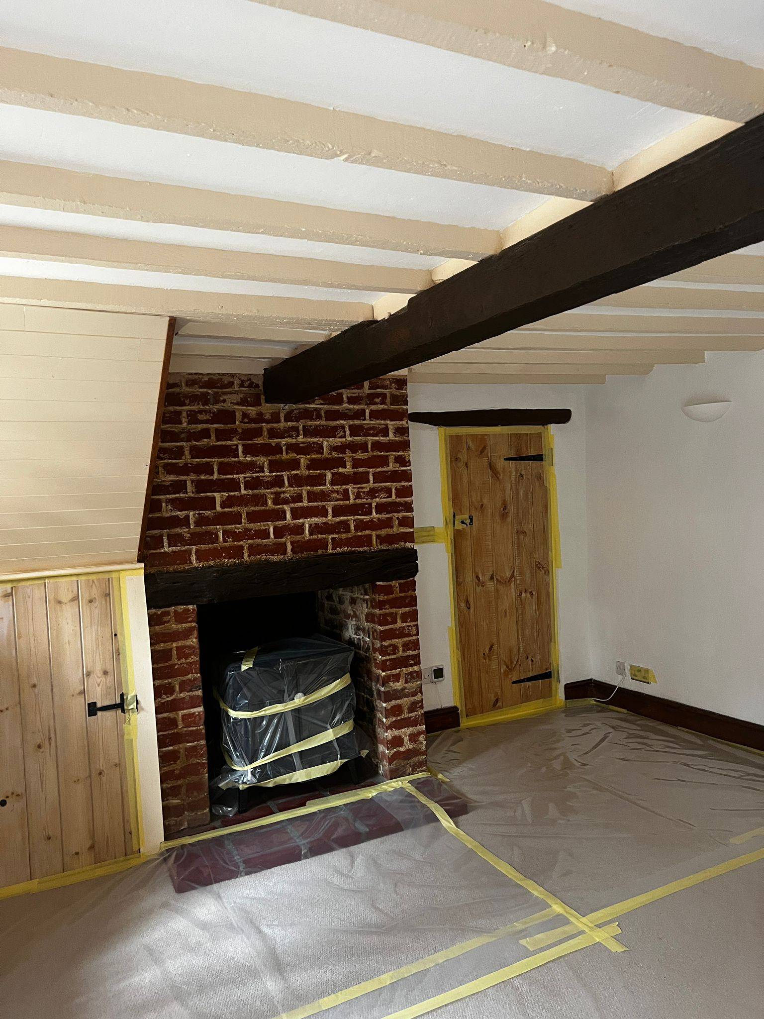 Restored room with fireplace and cleaned beams