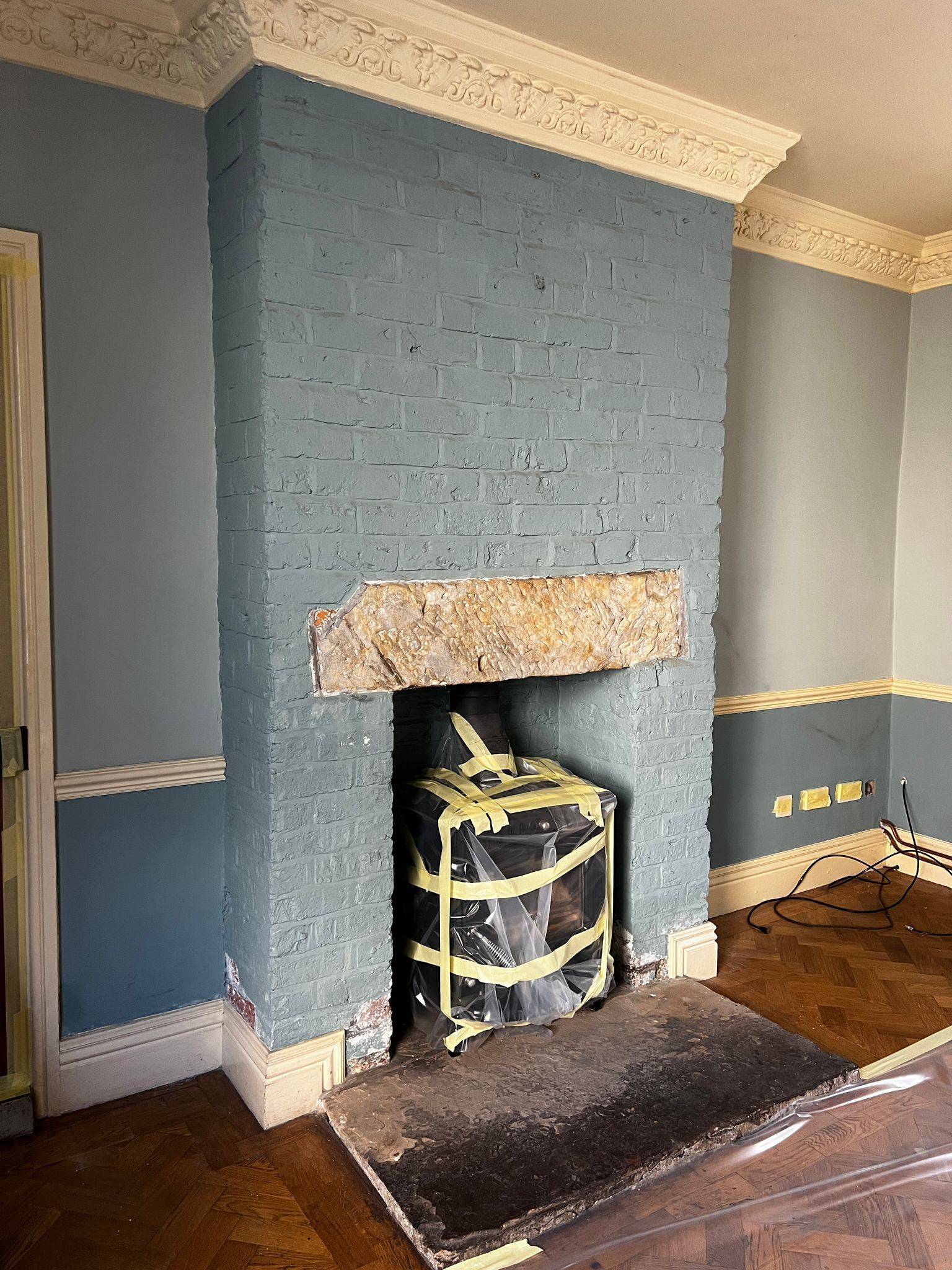 Painted brick fireplace before restoration
