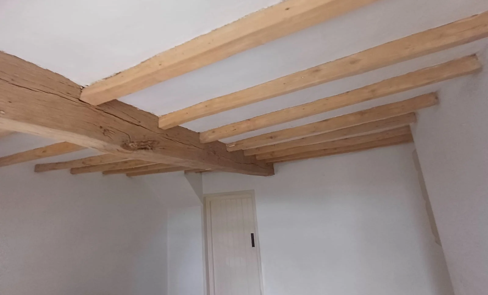 Room with lighter exposed oak beams after cleaning