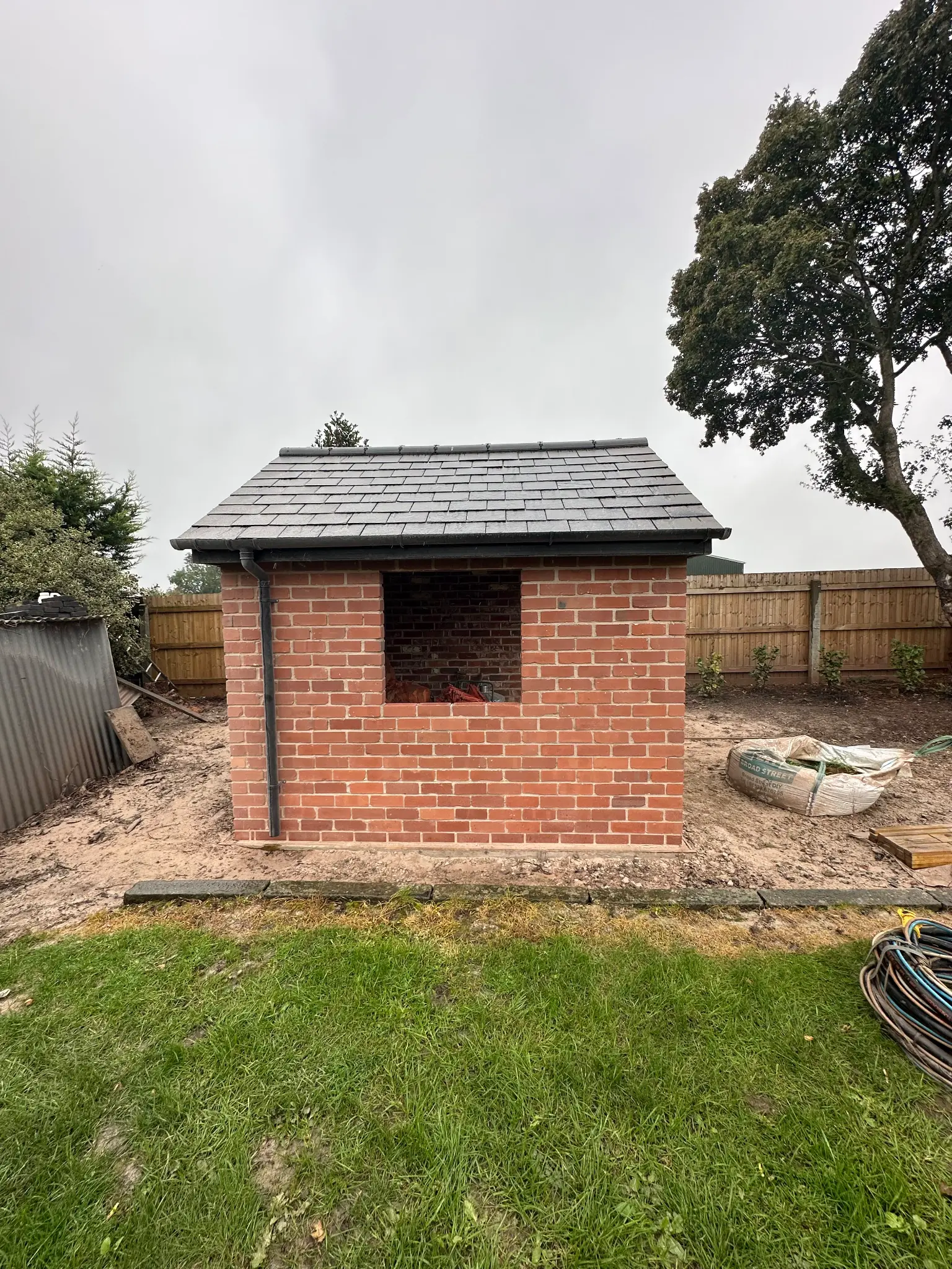 Rear brick elevation of a garden outbuilding after surface cleaning