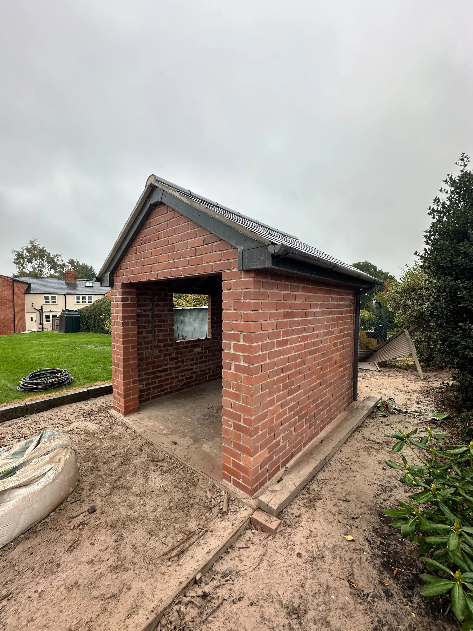 Side brick elevation of a garden outbuilding after surface cleaning