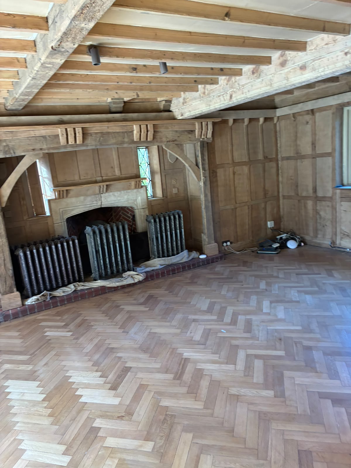 Grand Hall living area with lighter exposed timber after restoration