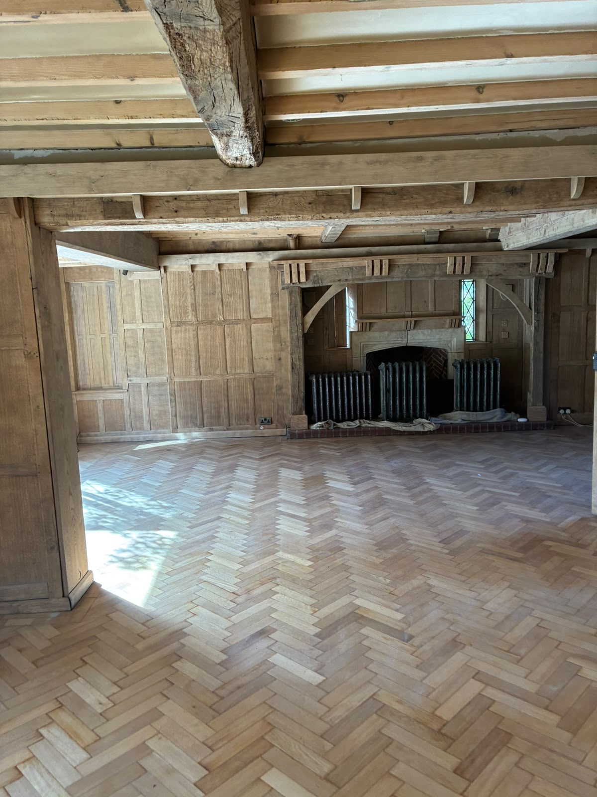 Grand Hall fireplace area with lighter cleaned timber after restoration
