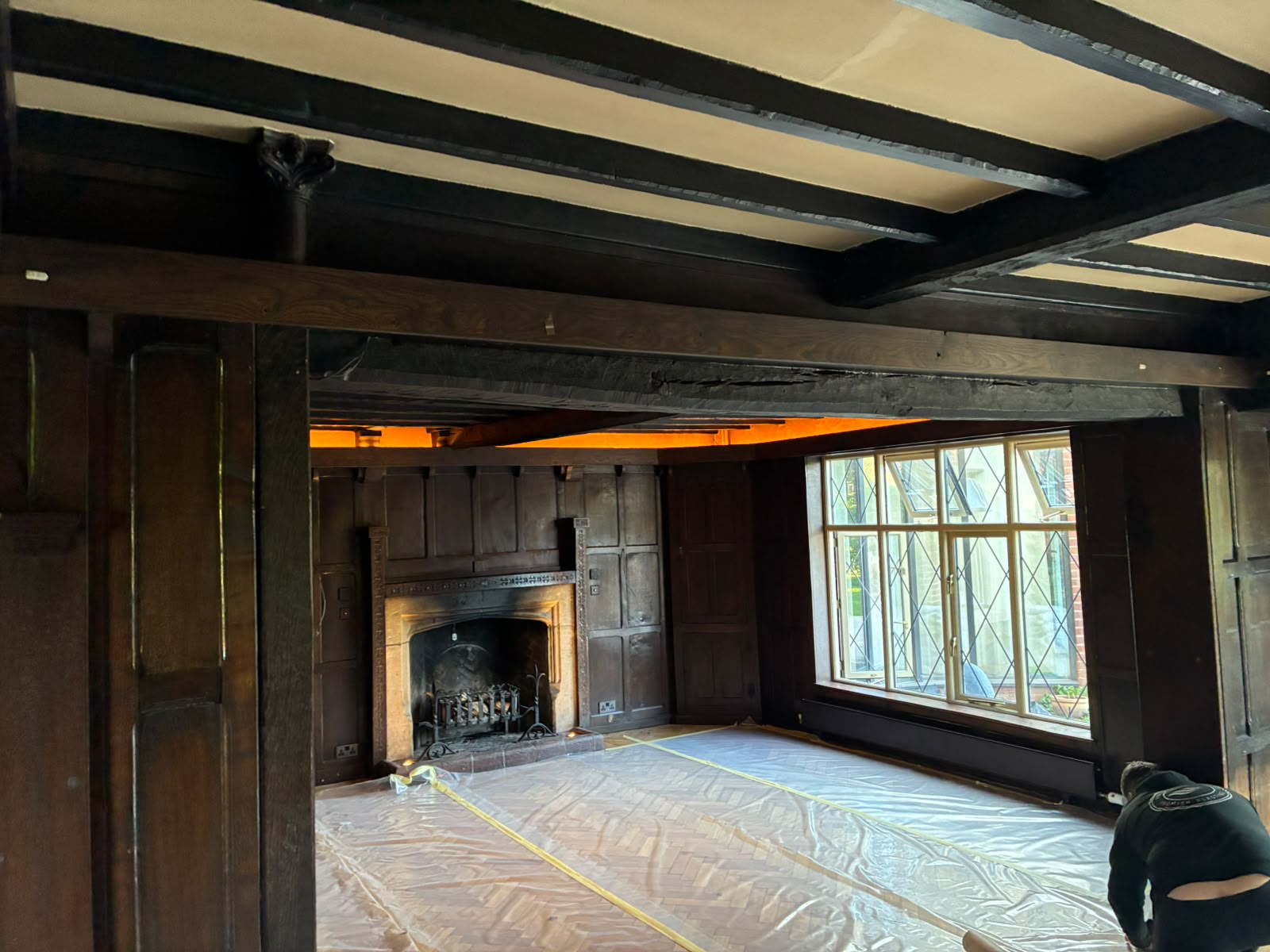 Grand Hall fireplace and dark timber panelling before restoration