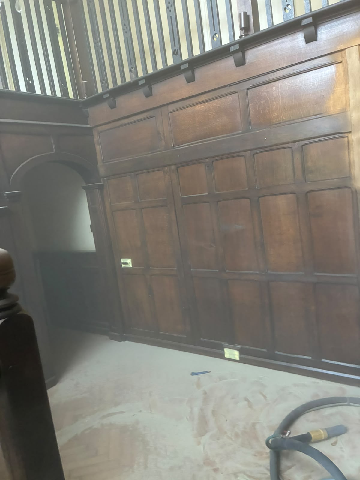 Grand Hall staircase with dark timber surfaces before restoration