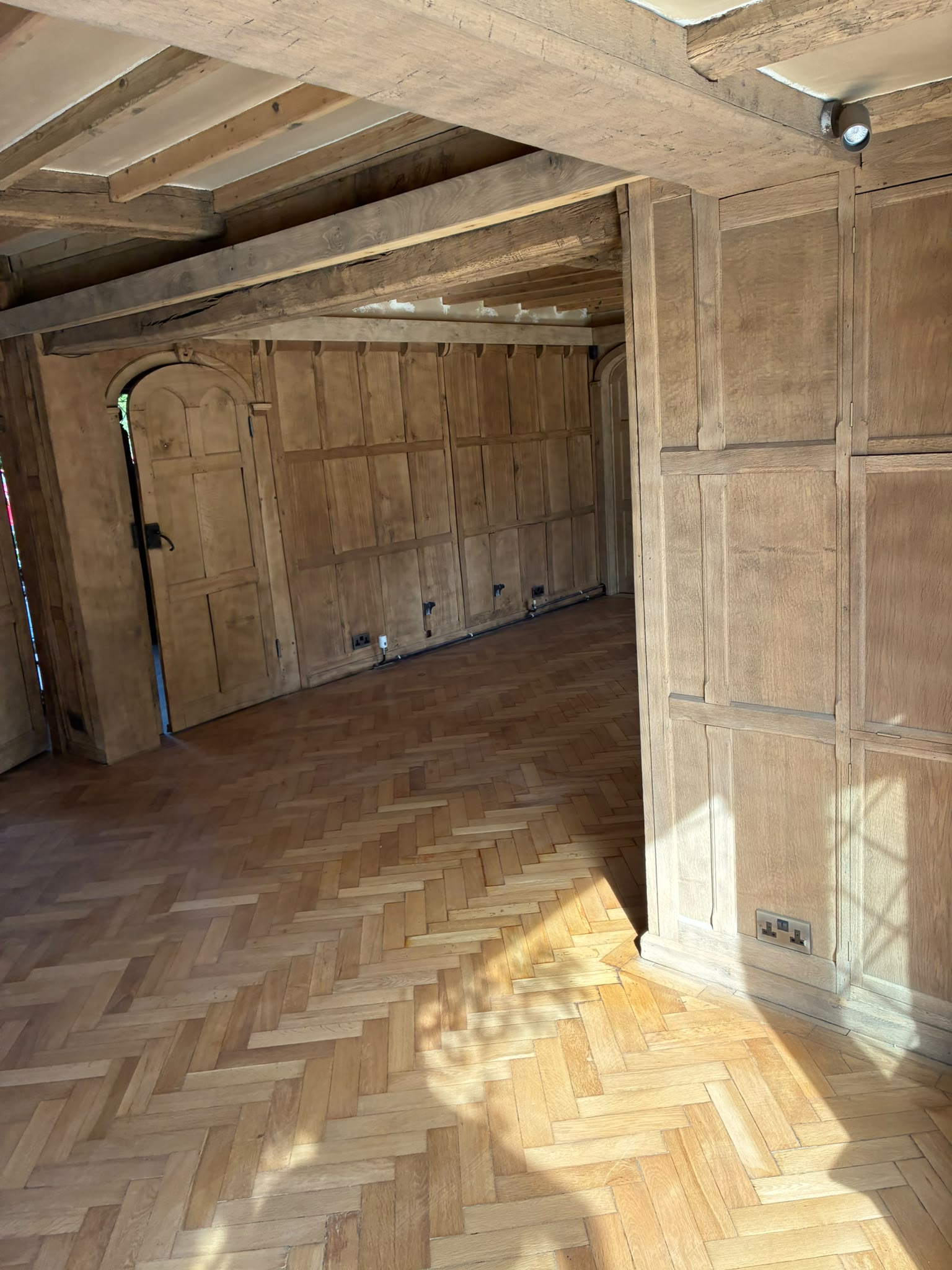 Grand Hall lower landing with lighter timber panelling after restoration