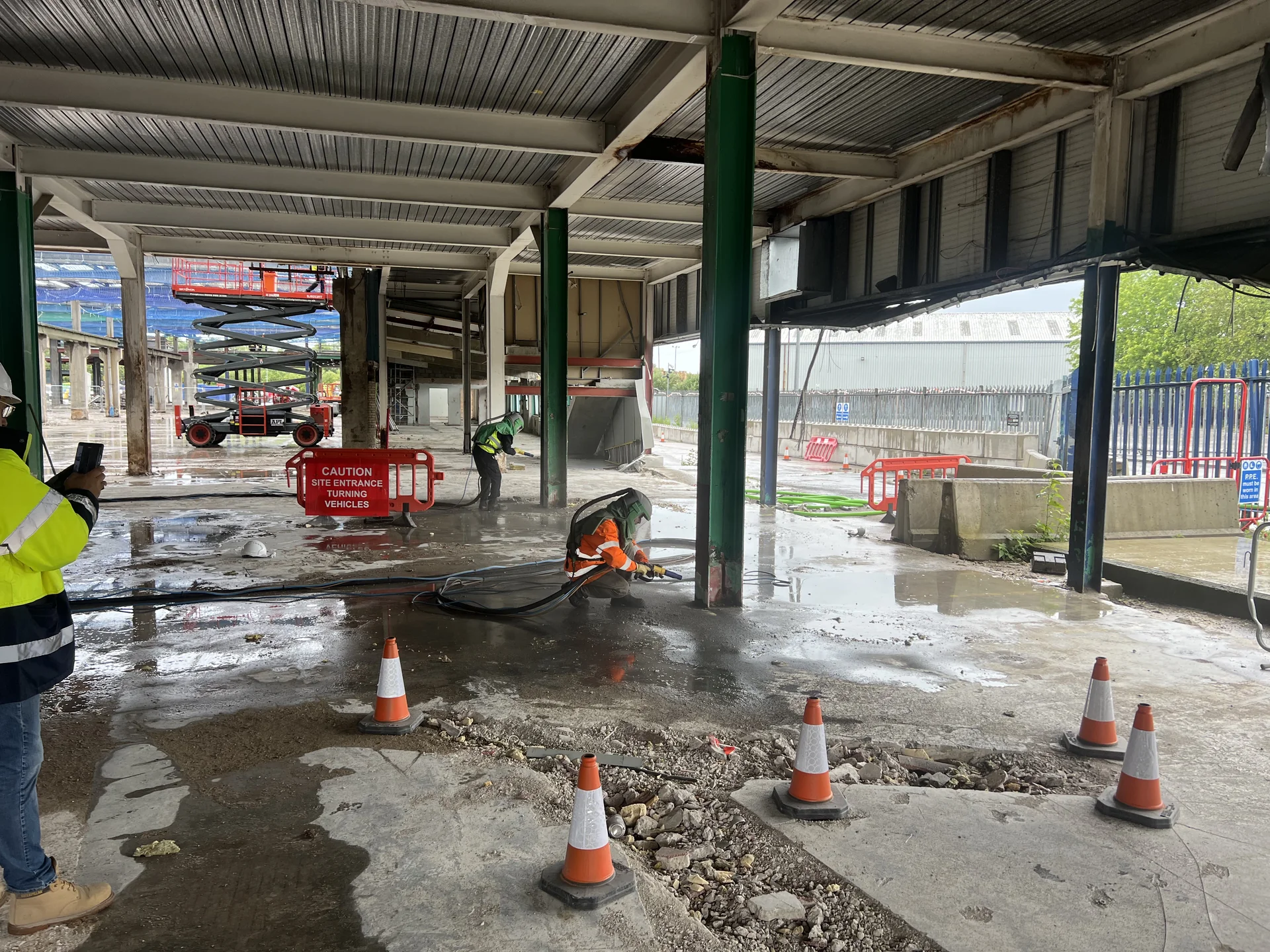 Commercial interior with steel support members during managed surface preparation