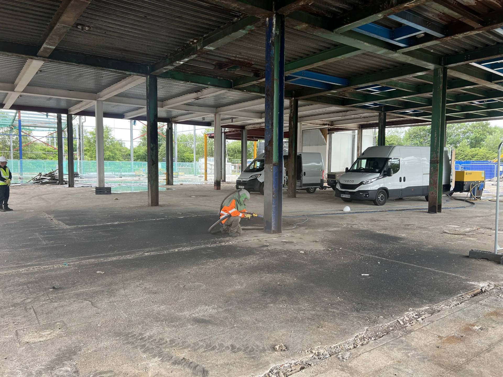 Operative preparing a steel support within a segregated commercial work area