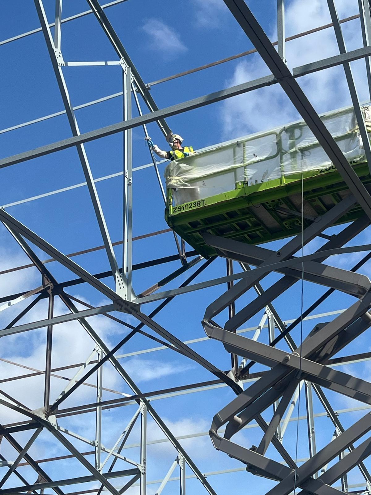 Intumescent fire-protective coating on prepared structural steelwork