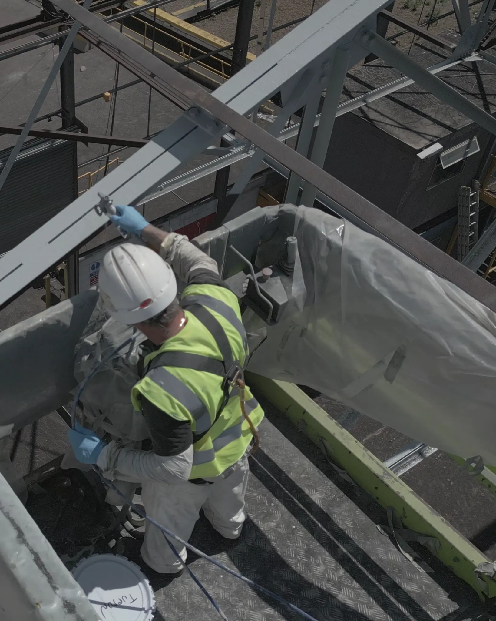 Protective paint application across prepared warehouse steelwork