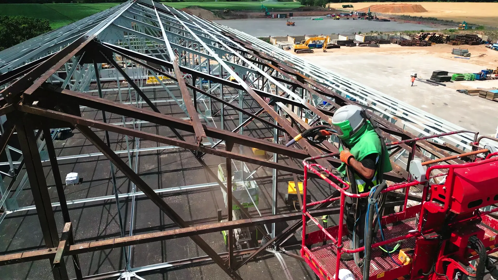 Abrasive blasting work taking place from a mobile elevated work platform