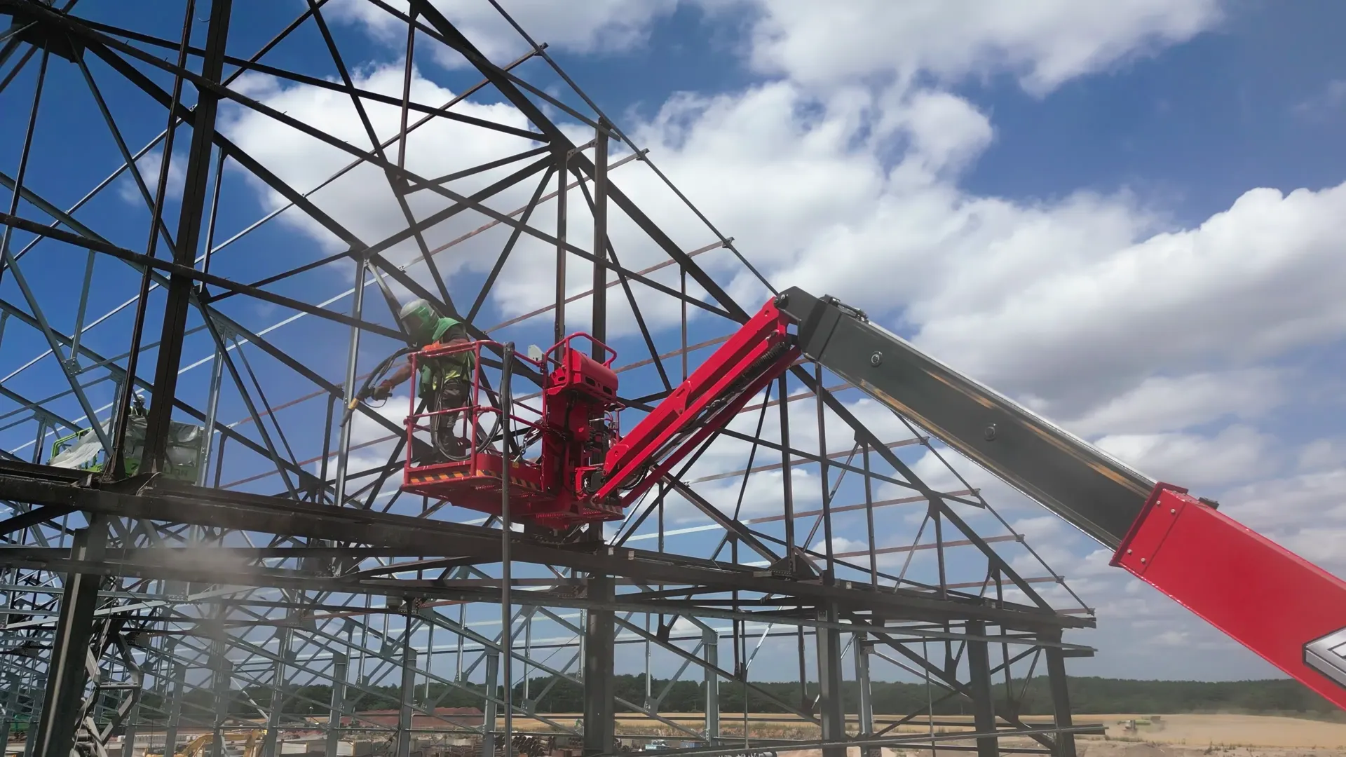 Low-angle view of the steel-framed warehouse structure during works