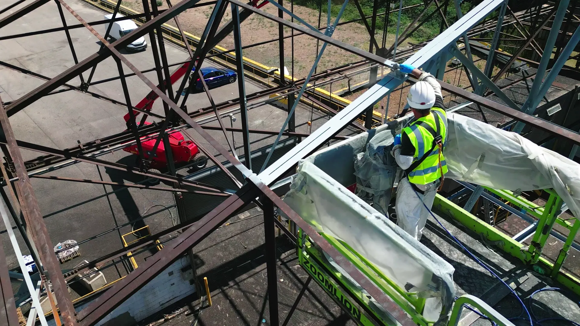 Close view of spray coating work on prepared steelwork